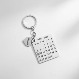 Custom engraved calendar date keychain photographed under soft white lighting