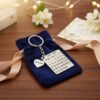 Gift box packaging with personalized calendar date keychain tied with ribbon