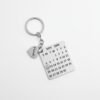 Single custom calendar keychain with engraved name charm on white background