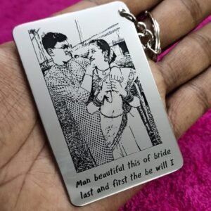 A metal pendant with a photo and text engraved on it attached to a metal key ring.