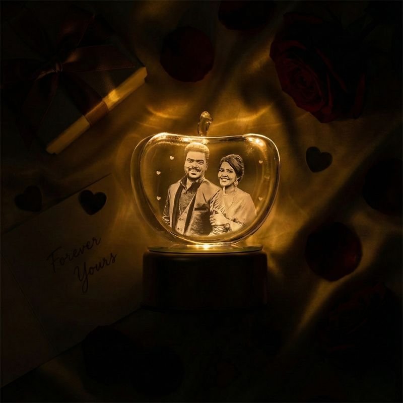 Apple-shaped RGB crystal photo lamp on wooden desk, romantic LED lighting with couple photo engraving.