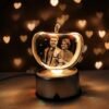 Warm golden apple crystal photo lamp surrounded by fairy lights and heart confetti, personalized photo anniversary gift.