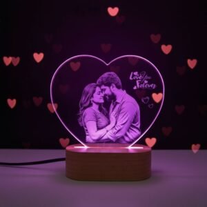 Close-up view of engraved couple photo on heart-shaped LED acrylic lamp glowing in soft purple light
