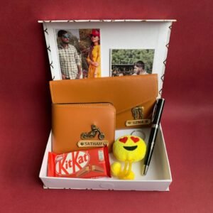 Personalized Anniversary Gift Hamper for Couple - Men Wallet 1.0, Ladies Minimal Clutch, Black Nexa Pen, Soft Toy Keychain, Kitkat, Two photos / Anniversary cards packed in a white fancy box.