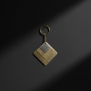 Close-up of personalized metal couple keychain showing engraved names, dates, and premium metal finish