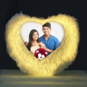 A white heart shape LED cushion pillow with a photo of a smiling couple on it