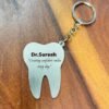 Custom name metal keychain for dentist - tooth shape, made of stainless steel.