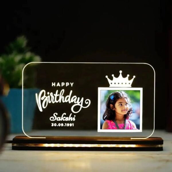 Personalized LED acrylic lamp with kid's picture and "Happy Birthday" text.
