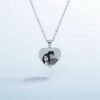 Elegant product shot of heart-shaped photo engraved pendant with reflection on white background