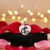 Heart-shaped custom photo engraved pendant surrounded by roses and candles – perfect romantic gift