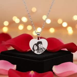 Heart-shaped custom photo engraved pendant surrounded by roses and candles – perfect romantic gift