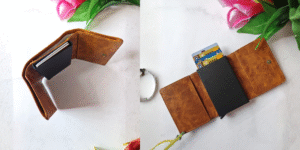 Open tan leather wallet with labels showing 1 cash slot, 2 card slots, 6 pop-up metal card slots, and magnetic closure — organized design.