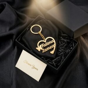 Personalized heart-shaped name keychain placed inside a premium black gift box with decorative filling
