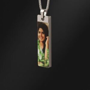 Personalized photo necklace with rectangular pendant and silver chain, full view displayed on marble background