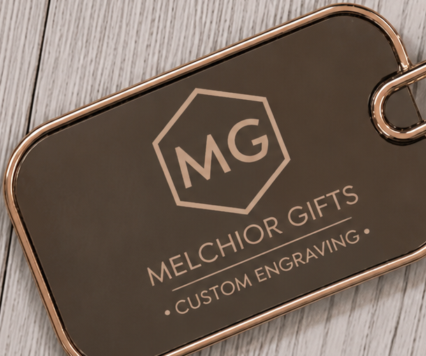Close-up of a company logo laser-engraved on a metal keychain plate