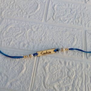 Personalised Bhai Name Rakhi – Evil Eye & Pearl Blue Thread with Gift Box & Card — lifestyle photo in real gifting setting