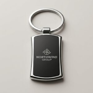 Close-up of a company logo engraved on the black panel of a rectangle keychain