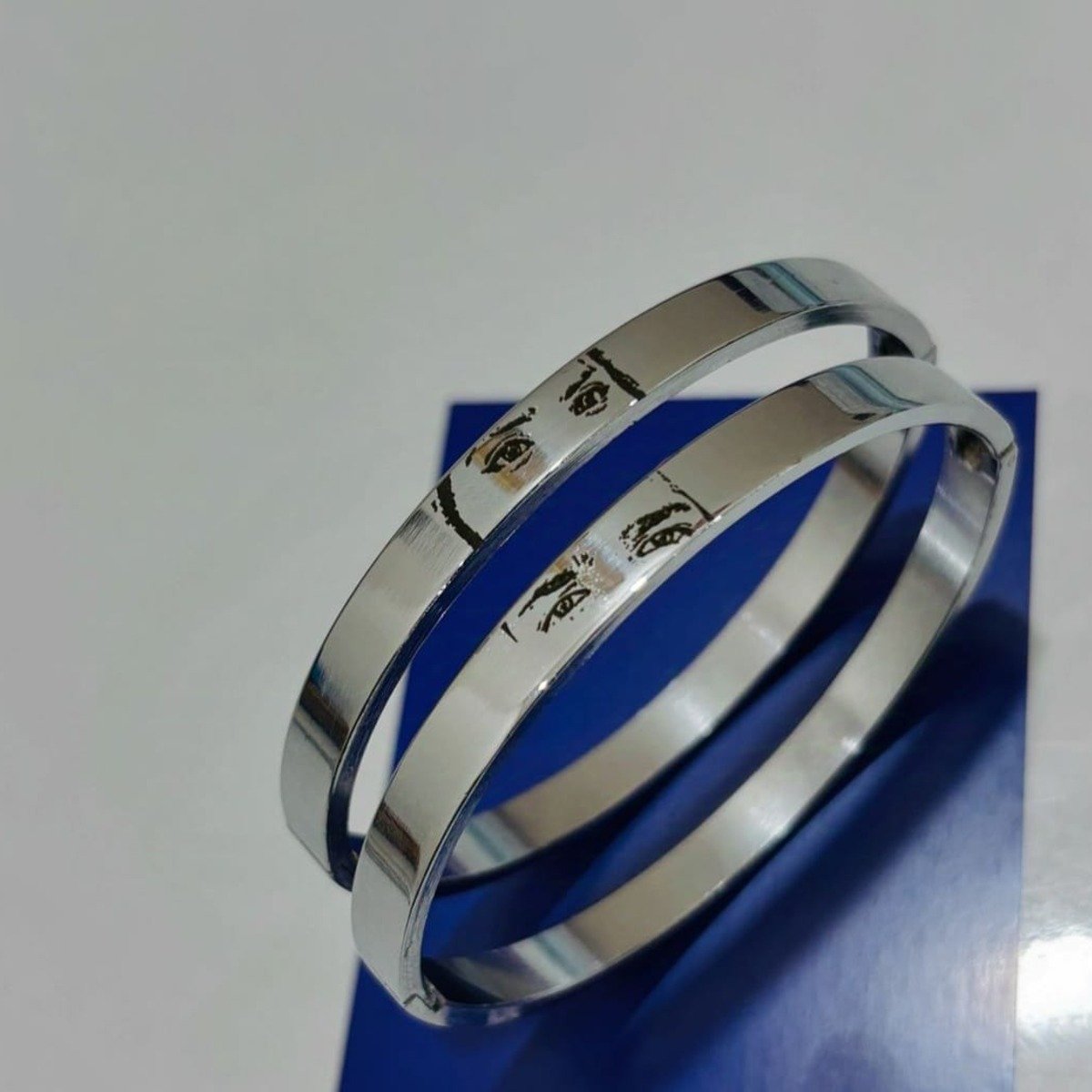 Pair of stainless steel kada bangles engraved with a photo of eyes