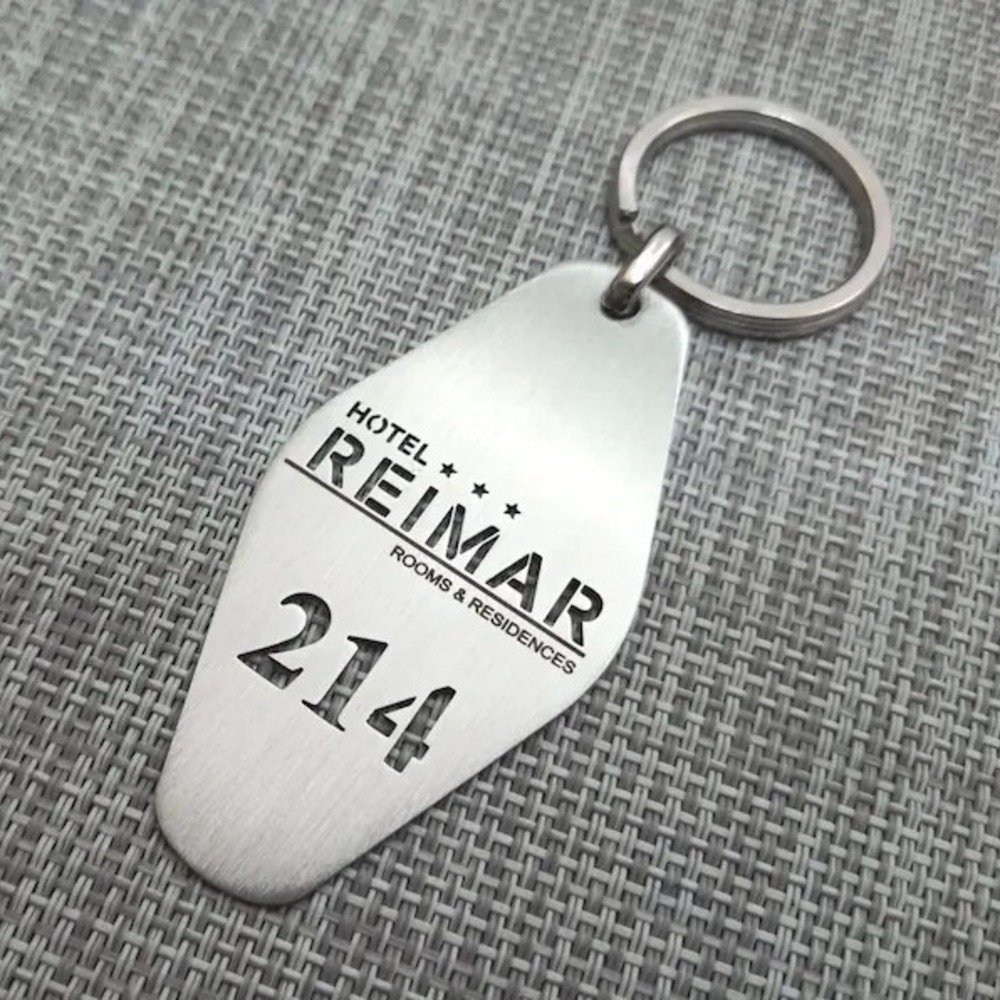 Stainless steel hotel-style key tag keychain engraved with hotel logo and room number 214